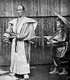Japan: A samurai posing with two swords and an attendant, c. 1900