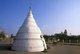 Thailand: A samlor rides passed the White Chedi near Chiang Mai’s municipal hall on the Ping River